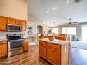 Open concept kitchen with stainless steel appliances, center island, and a seamless transition to the living areas at 22986 S 208Th St, Queen Creek, AZ 85142