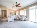 Bright living room featuring neutral tones, large windows, and a sliding glass door for a seamless indoor-outdoor flow at 22986 S 208Th St, Queen Creek, AZ 85142