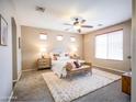 Serene bedroom with ample natural light, a ceiling fan, and a cozy rug at 22986 S 208Th St, Queen Creek, AZ 85142