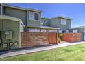 Well-kept two-story townhouse with green exterior, brick accents, and a private front yard area for relaxation at 2301 E University Dr # 488, Mesa, AZ 85213
