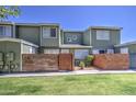 Attractive two-story townhouse with fresh green paint, a small yard, and a brick accent wall for added privacy at 2301 E University Dr # 488, Mesa, AZ 85213