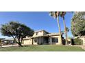 Inviting two-story home with manicured lawn, desert landscaping, tile roof, and bright natural light at 2549 E Desert Trumpet Rd, Phoenix, AZ 85048