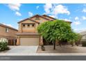 Inviting exterior of a two-story home with a well-manicured front yard and attached two-car garage at 3022 N Lainey Ln, Buckeye, AZ 85396