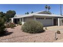 Single-story home with desert landscaping, decorative concrete accents and an attached two car garage at 3125 N 82Nd Pl, Scottsdale, AZ 85251