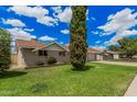 Lovely single-level home with a lush green lawn and a welcoming, serene neighborhood setting at 3814 W El Camino Dr, Phoenix, AZ 85051