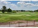 Scenic golf course view from property, featuring lush green fairways and mature trees at 4303 E Cactus Rd # 235, Phoenix, AZ 85032