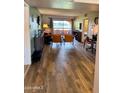 Inviting living area featuring wood-look floors and a sliding glass door with outside views at 4303 E Cactus Rd # 235, Phoenix, AZ 85032