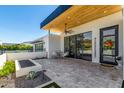 Outdoor patio with seating area, travertine tile, rock garden, and sliding glass doors at 5822 N 44Th Pl, Phoenix, AZ 85018