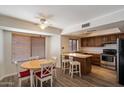 Eat-in kitchen features stainless steel appliances, wood cabinetry, and a dining area with natural light at 6614 S Mckemy St, Tempe, AZ 85283
