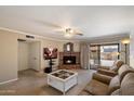 Inviting living room with brick fireplace, ceiling fan, and sliding glass doors to outdoor space at 6614 S Mckemy St, Tempe, AZ 85283