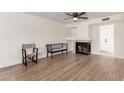 Cozy living room featuring a fireplace and wood-look floors at 7702 W Piute Ave, Glendale, AZ 85308