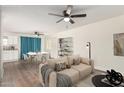 Open living space featuring a dining area, living room, and a glimpse of a well-equipped kitchen at 7702 W Piute Ave, Glendale, AZ 85308