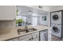 Convenient kitchen with stainless steel sink and nearby washer and dryer provides functionality and modern amenities at 9275 E Mission Ln # 206, Scottsdale, AZ 85258