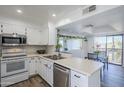 Bright kitchen featuring white cabinets, stainless steel appliances, and an island perfect for food prep and entertaining at 9275 E Mission Ln # 206, Scottsdale, AZ 85258