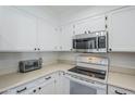 Well-equipped kitchen with stainless steel microwave and oven features ample cabinet space for efficient storage at 9275 E Mission Ln # 206, Scottsdale, AZ 85258