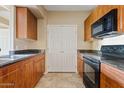 Kitchen features wood cabinets, stone countertops, and a pantry at 10136 E Southern Ave # 1052, Mesa, AZ 85209