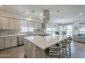 Modern kitchen with stainless steel appliances, a large center island, and stylish pendant lighting at 116 E Santa Lucia Ln, Queen Creek, AZ 85140