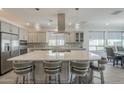 Open-concept kitchen with a large island, stainless steel appliances, and pendant lighting fixtures at 116 E Santa Lucia Ln, Queen Creek, AZ 85140