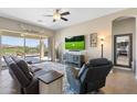 Bright living room with a ceiling fan and view to backyard at 12027 S 183Rd Dr, Goodyear, AZ 85338