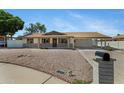Inviting single-story home boasts desert landscaping and a covered carport for convenience and sun protection at 1215 E Geneva Dr, Tempe, AZ 85282