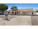 Lovely single-story home with desert landscaping and a spacious driveway leading to a convenient covered carport at 1215 E Geneva Dr, Tempe, AZ 85282