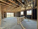 Unfinished home interior featuring wood framing, sliding glass doors, and views to the outside at 15793 W Beryl Ave, Waddell, AZ 85355