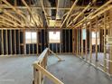Unfinished home interior featuring wood framing, rough electrical and views to the outside at 15793 W Beryl Ave, Waddell, AZ 85355