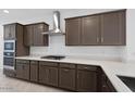 Modern kitchen boasts dark wood cabinets, stainless steel appliances, and quartz countertops at 16784 W Hope Dr, Surprise, AZ 85388