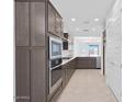 Contemporary kitchen showcases stainless appliances, ample cabinet space, and an open layout at 16784 W Hope Dr, Surprise, AZ 85388