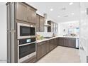 Stylish kitchen with stainless appliances, gas cooktop, abundant cabinetry, and bright lighting at 16784 W Hope Dr, Surprise, AZ 85388