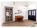 Bright entryway featuring tile floors, high ceilings, piano, and a decorative cabinet at 19276 N 90Th Pl, Scottsdale, AZ 85255