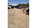Large backyard features a dirt lot, playhouse, several vehicles, and chain-link fencing at 20626 N 35Th Ave, Glendale, AZ 85308