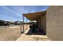 View of covered patio alongside home, with ladder, chairs, and miscellaneous outdoor equipment at 20626 N 35Th Ave, Glendale, AZ 85308