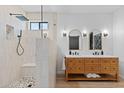 Bright bathroom featuring a double vanity, decorative mirrors, and a walk-in shower at 2239 N Calvin --, Mesa, AZ 85207