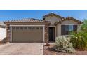 Charming single-story home featuring a brick driveway and a two-car garage at 26753 W Zachary Dr, Buckeye, AZ 85396