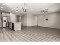 Spacious living room featuring hardwood floors, recessed lighting, and neutral paint at 26753 W Zachary Dr, Buckeye, AZ 85396