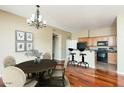 Open-concept living area with hardwood floors, dining space, and kitchen with an island at 2989 N 44Th N St # 2007, Phoenix, AZ 85018