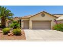 Charming home features a two-car garage and well-maintained desert landscaping, offering curb appeal at 3166 N 158Th Ave, Goodyear, AZ 85395