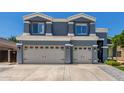 Two-story home with a two-car garage beneath matching windows at 3545 W Tanner Ranch Rd, San Tan Valley, AZ 85144