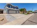 Exterior of two-story home with large driveway and manicured lawn at 3545 W Tanner Ranch Rd, San Tan Valley, AZ 85144