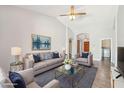 Bright, stylish living room with vaulted ceilings, comfortable seating, a ceiling fan, and contemporary decor at 4428 E Yawepe St, Phoenix, AZ 85044