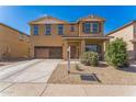 Two-story home with a brown stucco exterior and a well-maintained front yard at 45173 W Sandhill Rd, Maricopa, AZ 85139