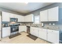 Bright kitchen with white cabinets, stainless steel appliances, and granite countertops at 45173 W Sandhill Rd, Maricopa, AZ 85139