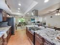 Modern kitchen with granite countertops, stainless steel appliances, a large island, and wood floors at 4639 W Keim Dr, Glendale, AZ 85301