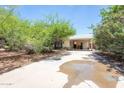 Single-story home with covered parking and mature landscaping, providing shade and curb appeal at 4719 N 70Th St, Scottsdale, AZ 85251