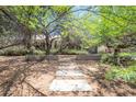 Landscaped front yard with mature trees creating a serene and inviting atmosphere at 4719 N 70Th St, Scottsdale, AZ 85251