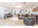 Spacious living room with travertine floors, comfortable seating, and ample natural light from a skylight at 4719 N 70Th St, Scottsdale, AZ 85251