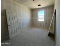 Cozy bedroom with a window view and neutral walls awaiting your personalization at 47705 W Moeller Rd, Maricopa, AZ 85139