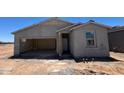 View of the home's exterior showcasing the garage and entry way prior to final construction at 47705 W Moeller Rd, Maricopa, AZ 85139