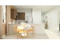 Bright kitchen with white countertops, a cozy breakfast nook, and modern appliances at 5040 S 234Th Ave, Buckeye, AZ 85326